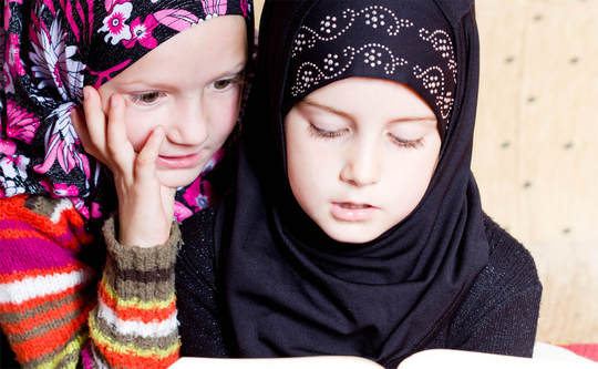 Two hijab girls reading. ADaBi books.